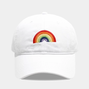 Close-up of rainbow embroidery detail on a white cotton baseball cap with curved brim