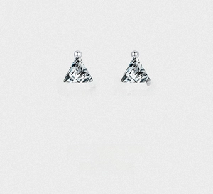 Macro detail of S925 silver triangle zircon studs with elegant three-prong setting