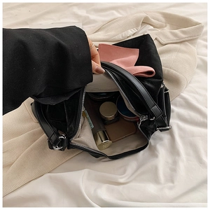 Internal view of velvet handbag with pink bow showing capacity for cosmetics and items