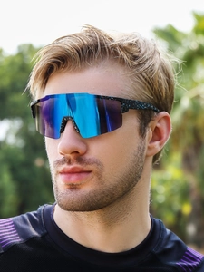 Detail of outdoor cycling sunglasses featuring blue mirrored lenses and blue ink splatter frame