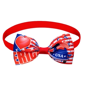 Close-up of patriotic American flag dog bowtie with USA letters and striped ribbon texture