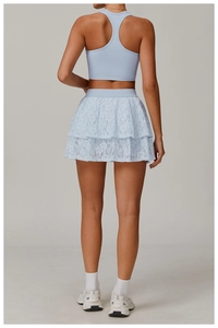 Rear view of a light blue lace layered sports skirt and racerback yoga vest set