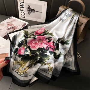 Elegant silk peony scarf with traditional Chinese ink painting art on a dark backdrop