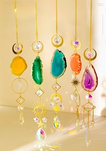 Detail of five colorful agate slice suncatchers with crystal prisms and gold metal chains