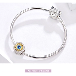 Detailed view of S925 sterling silver snake chain bracelet with evil eye and cat charms