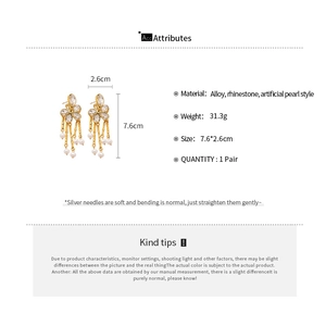 Detail showing dimensions and material of floral tassel earrings with pearls and rhinestones