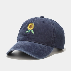 Detailed side view of washed navy cotton baseball cap with sunflower embroidery
