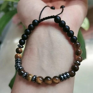 Detail of Morse code bracelet featuring tiger eye and matte black onyx beads
