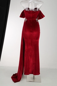 Detail of red velvet evening gown showing shimmering rhinestone tassels on the waistline