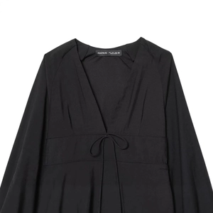 Elegant black deep V-neck long sleeve dress with waist tie and silky finish on white back