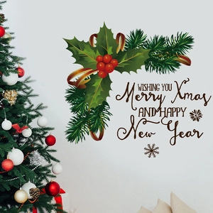 Detail of Christmas wall stickers featuring festive green leaf wreaths and red berries
