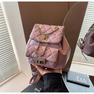 Detail of lavender quilted faux leather backpack with gold clasp and chain strap