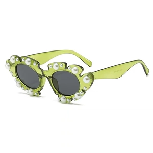 Fashionable green resin sunglasses for women with wavy frames and pearl embellishments