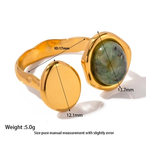 Détail d'une bague ouverte dorée à l'or 18 carats avec pierre naturelle et texture martelée