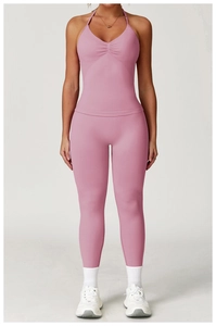 Close-up of pink high-waist seamless yoga pants with pleated halter neck sports bra set