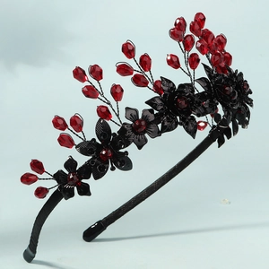 Detail of Gothic headband featuring black metal flowers and red teardrop beads