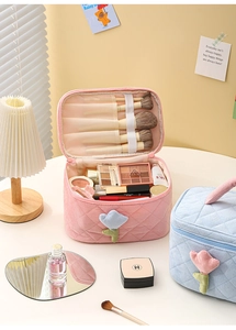 Detail of corduroy makeup bag with 3D flower decoration and makeup brush compartment