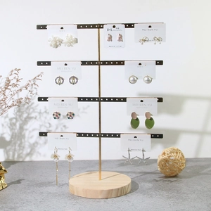 Detail of assorted metal earrings on a jewelry display rack with various styles