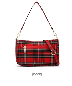 Detail view of the back zipper pocket on a red plaid canvas baguette shoulder bag
