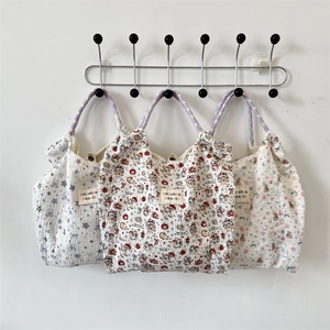 Detail of seersucker tote bags featuring cartoon patterns and star prints with woven handles