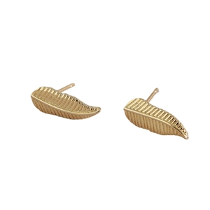 Elegant gold leaf earrings with textured vein details in a minimalist geometric style