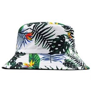 Close-up of tropical palm leaf print and reinforced stitching on white canvas bucket hat