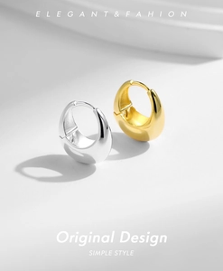 Close-up of thick polished S925 sterling silver hoop earrings in gold and silver finish