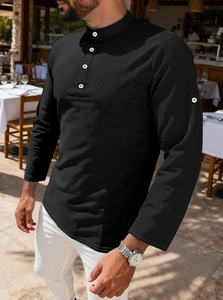 Detail shot of men's black waffle knit polo shirt showing texture and contrast buttons
