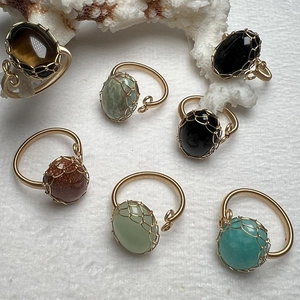 Detail view of handmade tiger eye stone rings with 14K gold-filled wire wrap