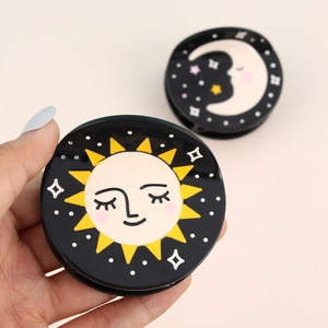 Chic black acetate hair claw clips featuring celestial sun and moon patterns for women