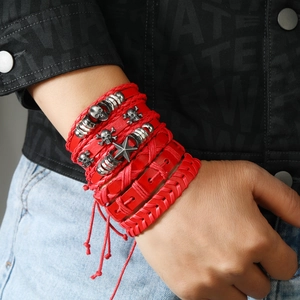 Bracelet multicouche punk en cuir rouge avec crâne et étoiles porté par un homme stylé