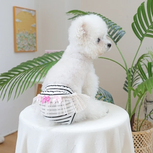 Detail of dog sanitary pants featuring black white stripes and pink sequin lace bows