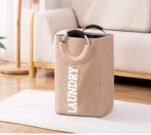 Detail of reinforced aluminum handles and khaki linen fabric on laundry basket
