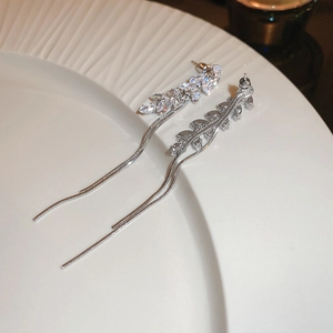 Detail shot of silver wheat-shaped zircon earrings with long tassel snake chains