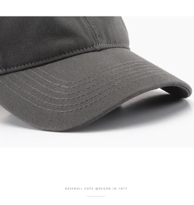 Macro shot of dark grey washed cotton fabric and reinforced stitching on baseball cap