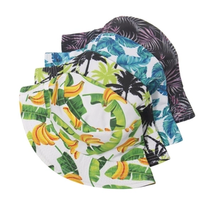 Flat lay showing variety of bucket hats with tropical banana and palm leaf prints