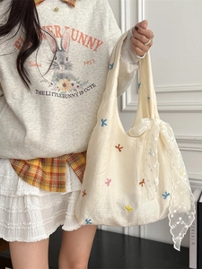 Off-white tulle tote bag with colorful cherry embroidery and decorative lace ribbon