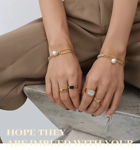 Detail of vintage 18K gold-plated titanium steel chain bracelet with pearl and rings