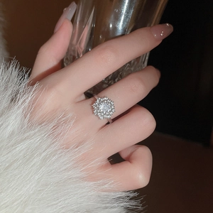 Macro shot of silver rotating snowflake ring with zircon inlay and floral cluster details