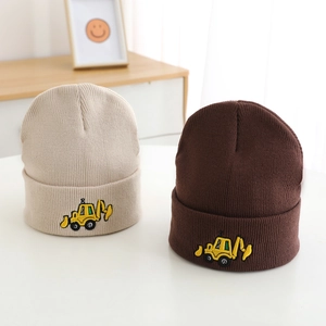 Close-up of beige and brown knit hats with yellow excavator embroidery detail