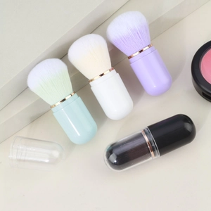 Portable capsule makeup brush set in pastel colors with rose gold accents and clear caps