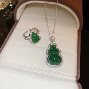 Close-up of green resin gourd jewelry set with zircon necklace and open ring in gift box
