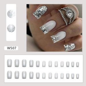 Macro detail of French white tip glitter press-on nails with full 24-piece set display
