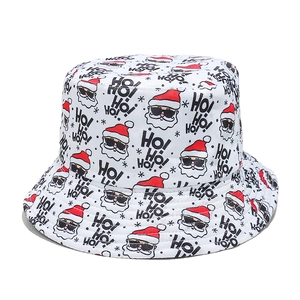 Detail of Christmas bucket hat with Santa Claus and HO pattern print on white fabric