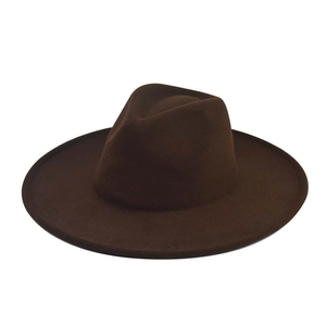Flat lay of dark brown wide-brimmed felt fedora hat made of thick wool on white background