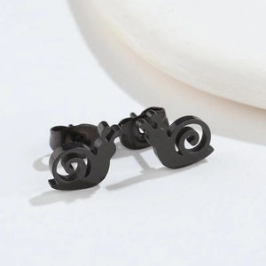 Macro detail of minimalist black snail stud earrings in matte finish stainless steel