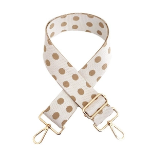 Detail of wide adjustable shoulder strap with brown polka dots and gold metal lobster clasps