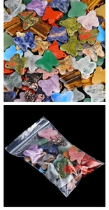 Detailed view of various natural stone butterfly pendants with pre-drilled holes for DIY