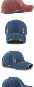 Close-up of distressed washed denim baseball caps with vintage frayed holes and metal buckle