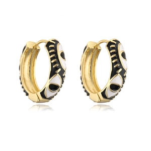 Close-up of 18K gold plated hoop earrings featuring black and white enamel eye patterns